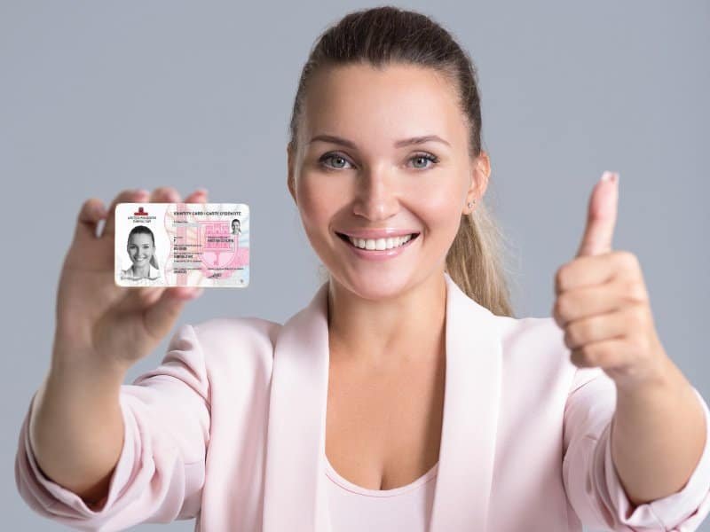 Blonde woman holding a Red ID card issued in Gibraltar
